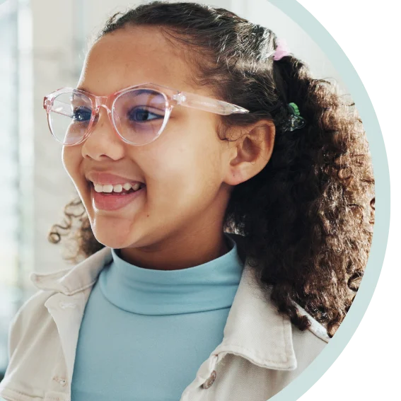 Young girl picking out glasses